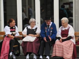 People in Swiss Costume on Bench celebrating Swiss National Day