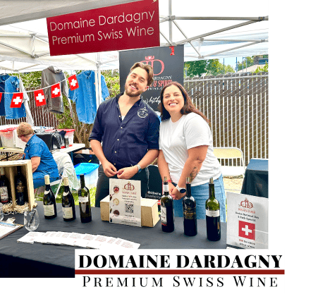 Image of booth for Domaine Dardagny with a man and a women working by a table of wine